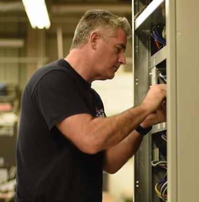EmergencyHVACs Technician at Work - Replacing HVAC Panel EmergencyHVACs technician carefully re‑attaching an HVAC unit’s access panel